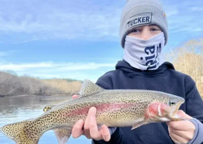 Young angler holding a rainbow trout