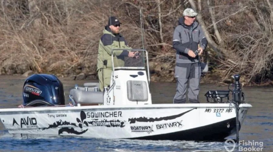 Two anglers are fishing from a boat on Branson Lake